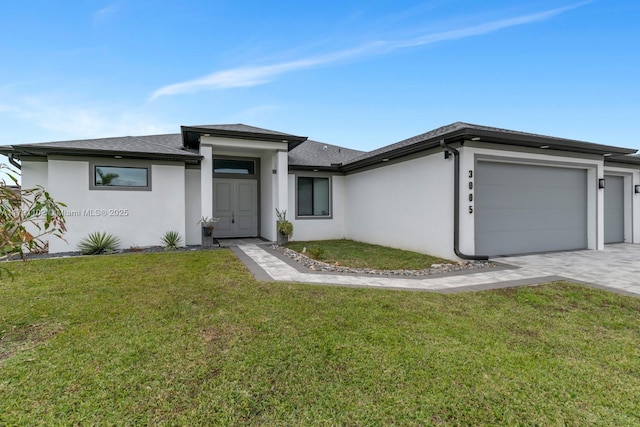 view of front of home featuring a garage and a front lawn