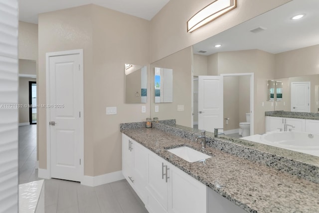 bathroom with toilet, vanity, tile patterned flooring, and walk in shower