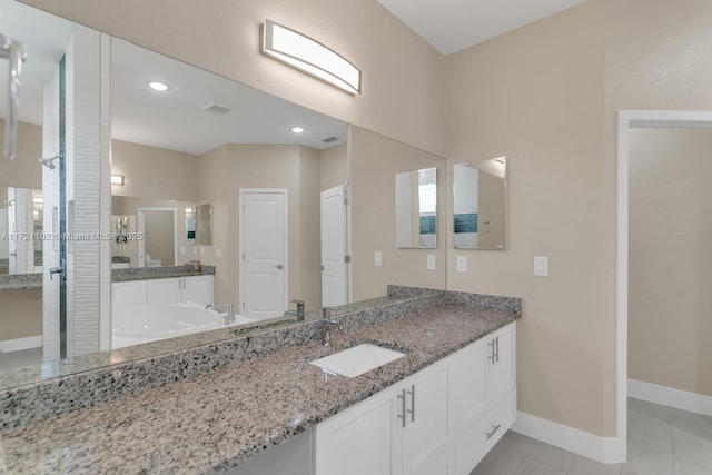 bathroom with tile patterned floors and vanity