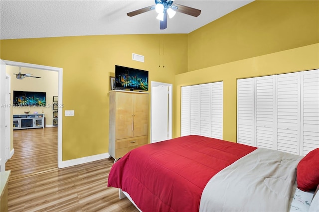 bedroom with lofted ceiling, ceiling fan, and hardwood / wood-style flooring