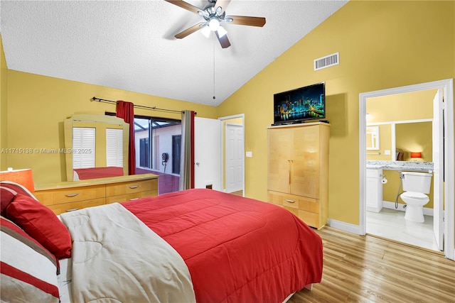 bedroom with lofted ceiling, access to exterior, ceiling fan, hardwood / wood-style flooring, and ensuite bath