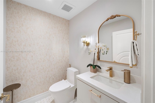 bathroom featuring vanity and toilet