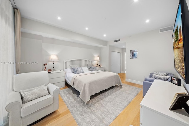 bedroom featuring light hardwood / wood-style floors and a closet