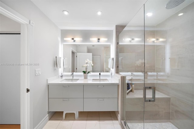 bathroom with tile patterned flooring, vanity, and a shower with shower door