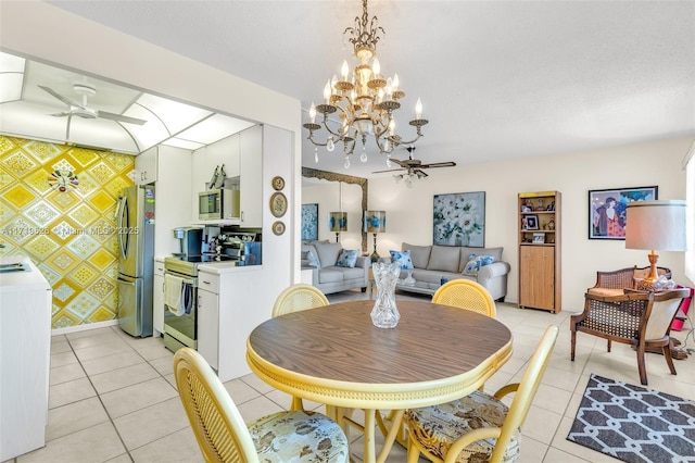 dining room featuring light tile patterned floors and ceiling fan with notable chandelier