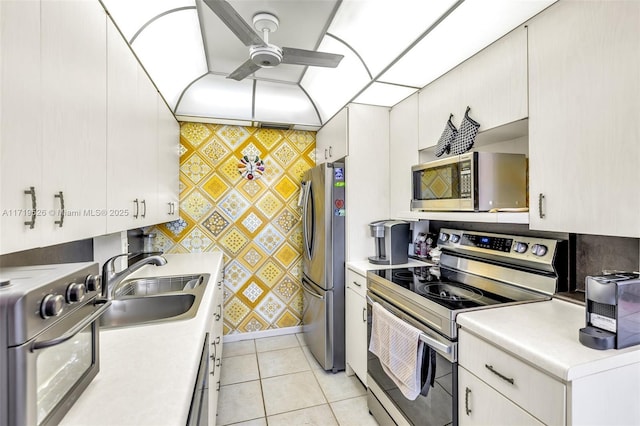 kitchen featuring white cabinetry, ceiling fan, sink, and appliances with stainless steel finishes