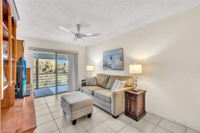 tiled living room featuring ceiling fan and a textured ceiling