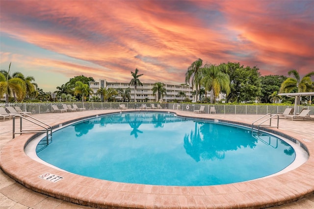 pool at dusk with a patio