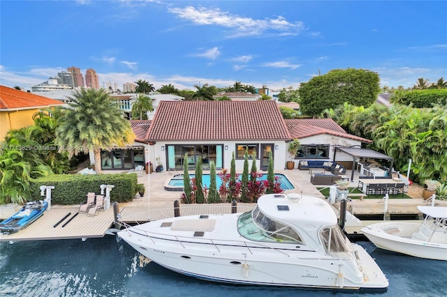 view of dock with a patio area and a water view