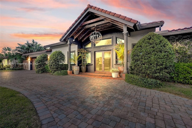 exterior entry at dusk with french doors