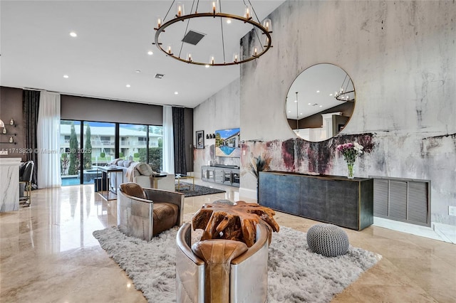 living room featuring a notable chandelier and a towering ceiling