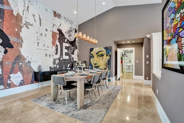 dining space featuring a high ceiling and an inviting chandelier