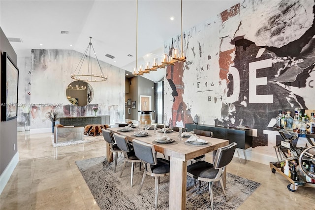 dining room with high vaulted ceiling