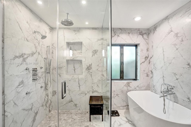 bathroom featuring shower with separate bathtub and tile walls