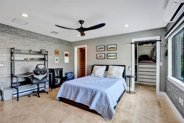 bedroom with ceiling fan and a wall mounted AC