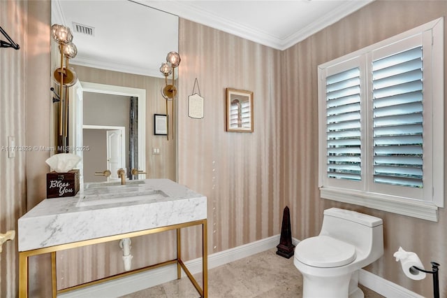 bathroom featuring vanity, toilet, and ornamental molding