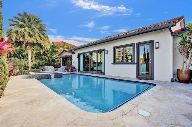 view of swimming pool featuring an in ground hot tub and a patio