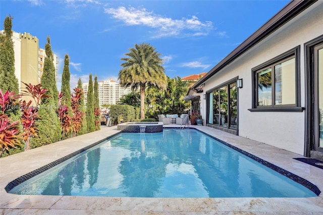 view of pool featuring an in ground hot tub