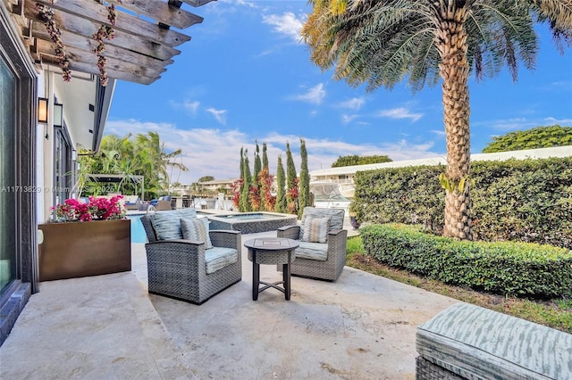 view of patio / terrace with an in ground hot tub and a pergola