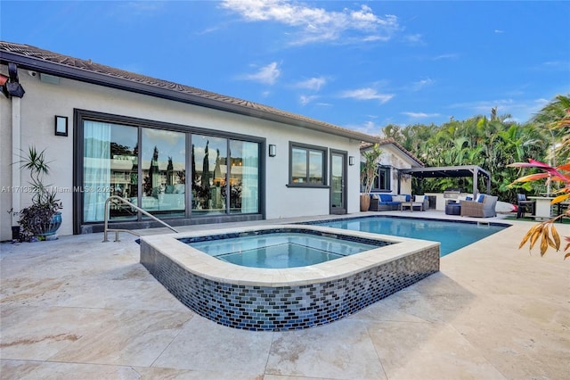 view of pool featuring outdoor lounge area, an in ground hot tub, and a patio area