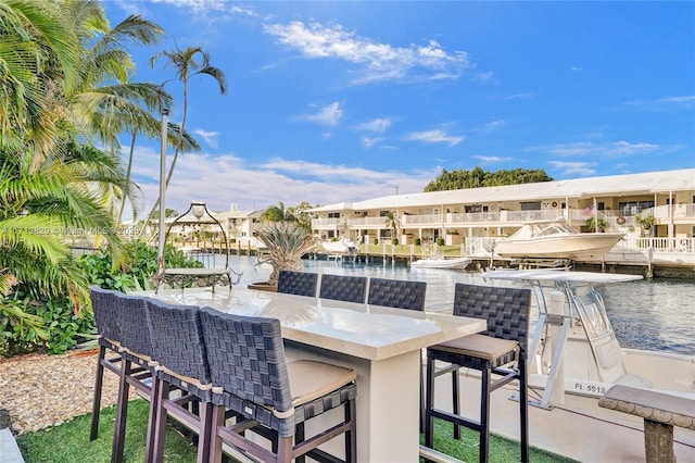 view of patio featuring a bar and a water view