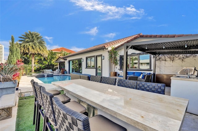 view of patio featuring area for grilling, an outdoor hangout area, and an outdoor wet bar