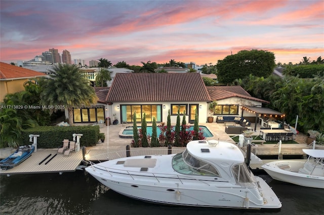 dock area featuring a patio area, an outdoor hangout area, and a water view