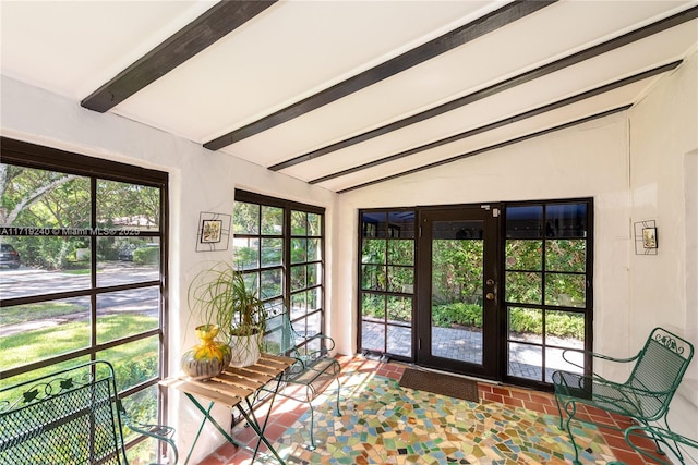 sunroom with vaulted ceiling with beams