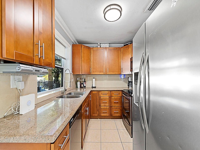 kitchen featuring light stone countertops, sink, stainless steel appliances, crown molding, and light tile patterned flooring