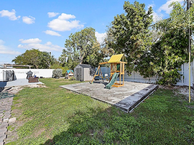view of playground with a patio, a storage shed, and a lawn