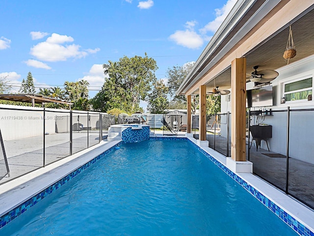 view of swimming pool with an in ground hot tub, a patio, and ceiling fan