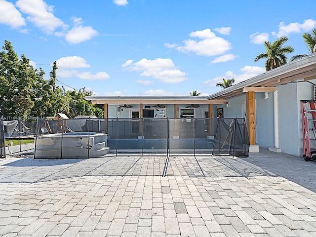 exterior space with a patio, ceiling fan, and a swimming pool