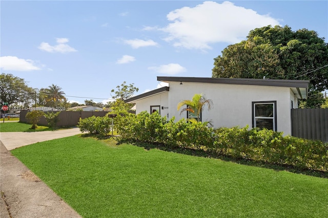 view of property exterior with a lawn