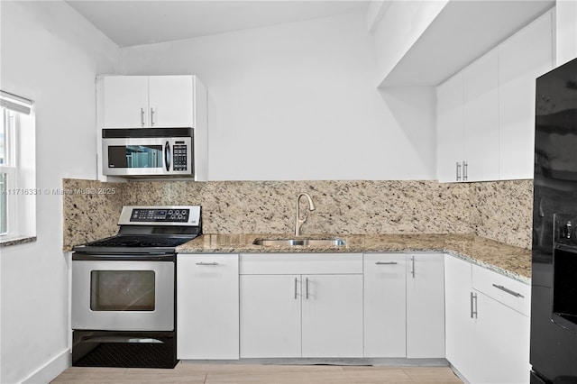 kitchen with white cabinetry, sink, and appliances with stainless steel finishes