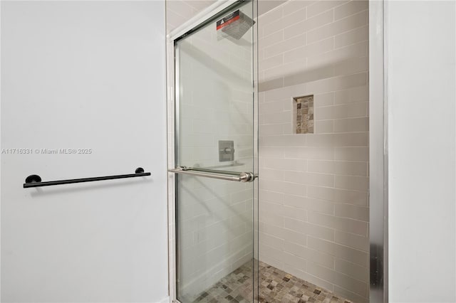 bathroom with a shower with door