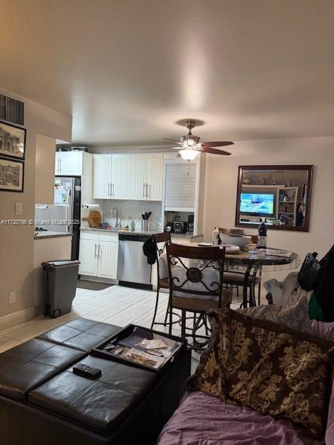 interior space with ceiling fan and sink