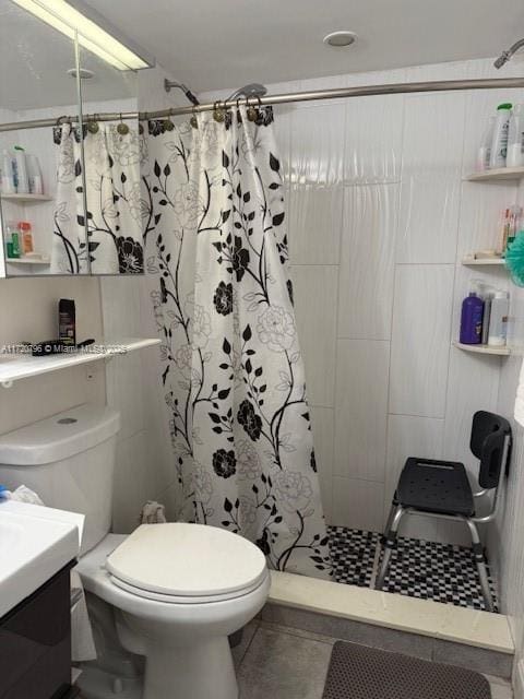 bathroom with tile patterned floors, vanity, toilet, and walk in shower