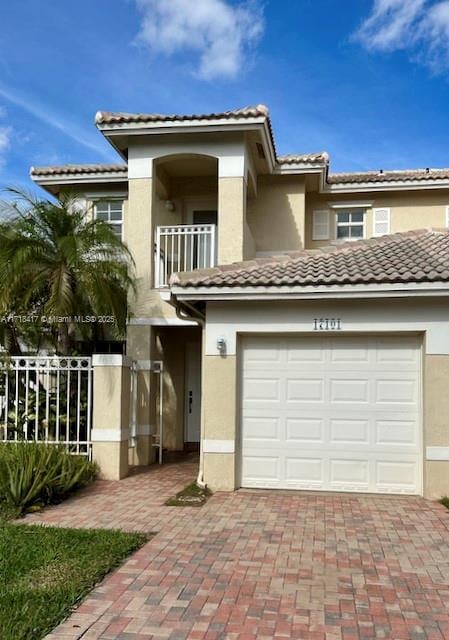 view of front of property with a balcony and a garage