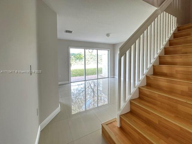 stairway featuring tile patterned floors