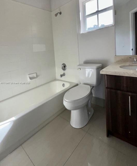 full bathroom featuring tile patterned floors, vanity, tiled shower / bath combo, and toilet