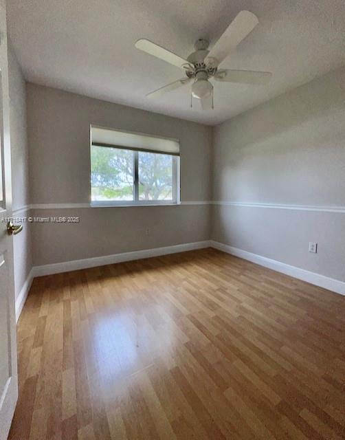 spare room with a textured ceiling, hardwood / wood-style flooring, and ceiling fan