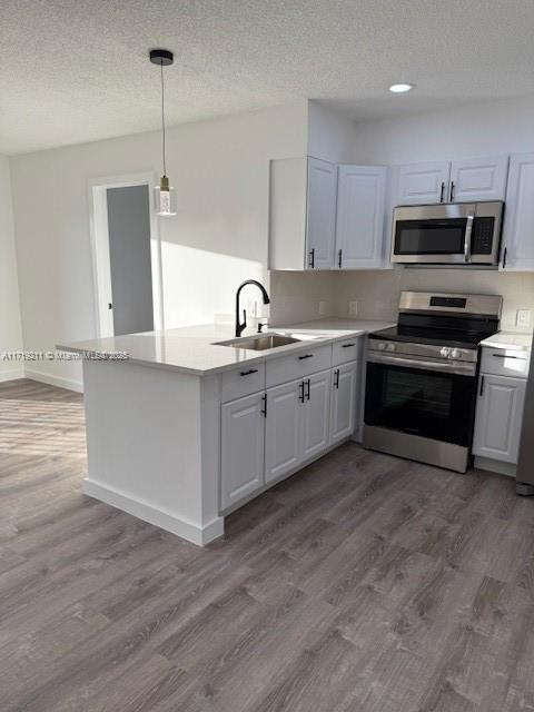 kitchen featuring white cabinetry and appliances with stainless steel finishes