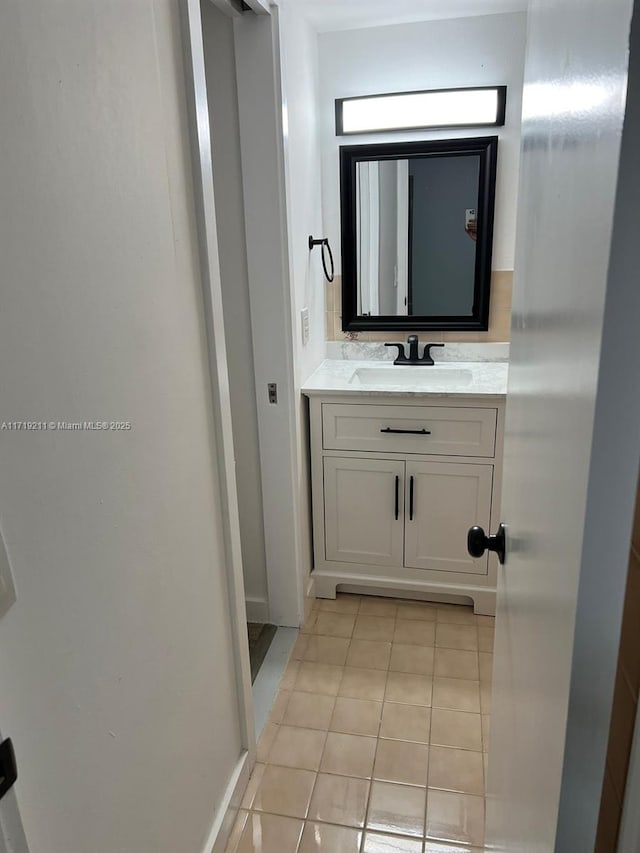 bathroom featuring tile patterned flooring and vanity