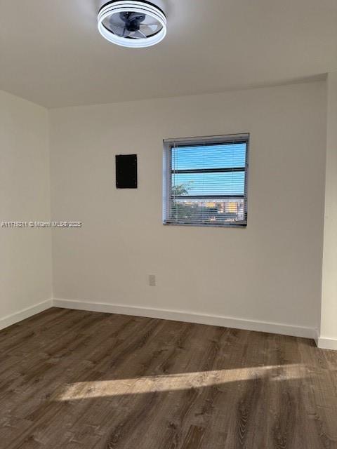 unfurnished room featuring dark hardwood / wood-style flooring