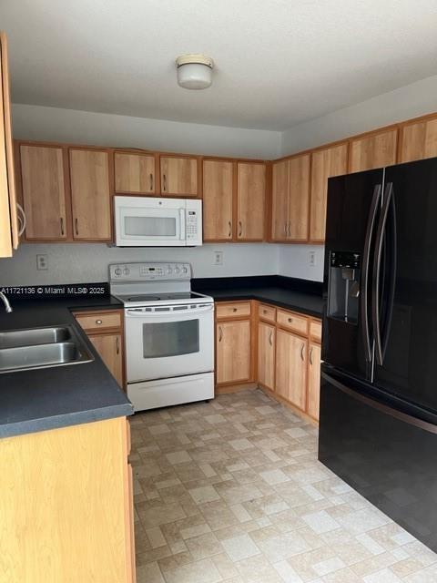 kitchen featuring sink and white appliances