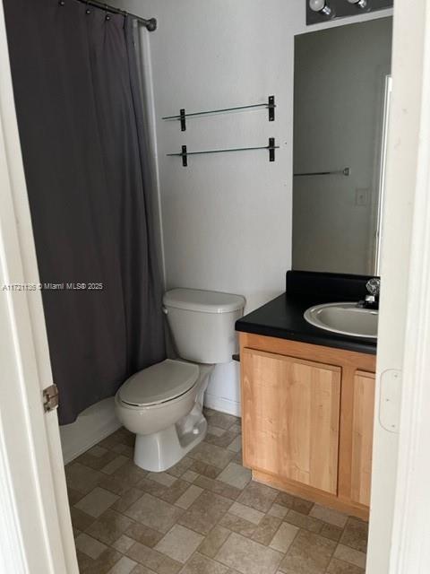 bathroom featuring vanity and toilet