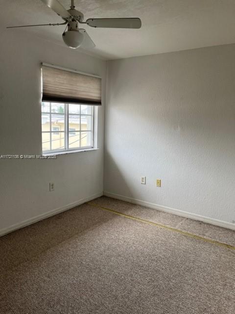 unfurnished room with carpet floors and ceiling fan