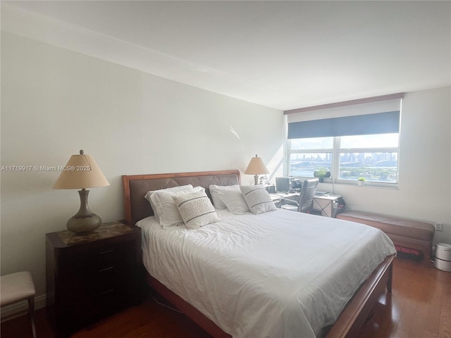 bedroom with dark wood-type flooring