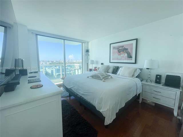 bedroom featuring dark hardwood / wood-style floors and a wall of windows