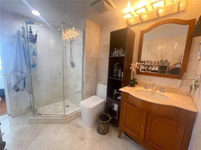 bathroom featuring toilet, vanity, and walk in shower